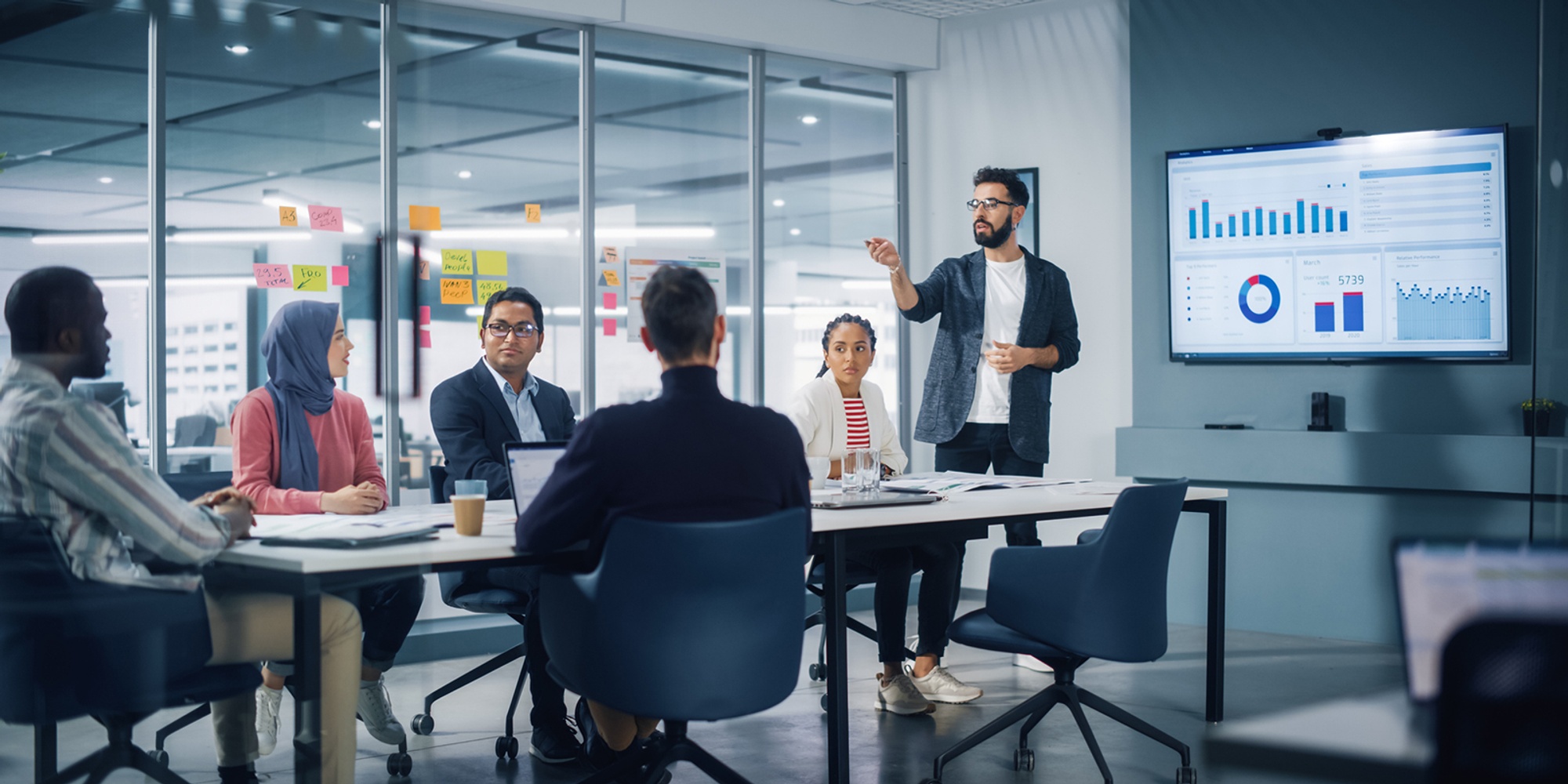 Workers in a conference room watching a presentation