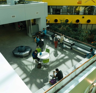 Students socializing in the atrium of the Alief Hayes Campus