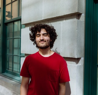 Male college student smiling at HCC Central Campus