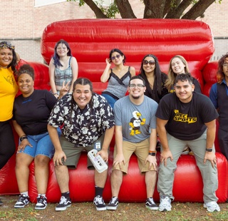 Students gathered in front of an inflatable bounce attraction during an event on campus