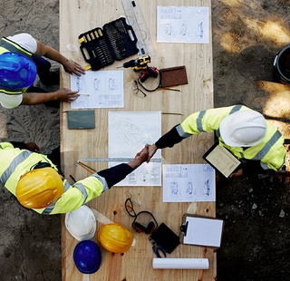 Construction workers going over a blueprint