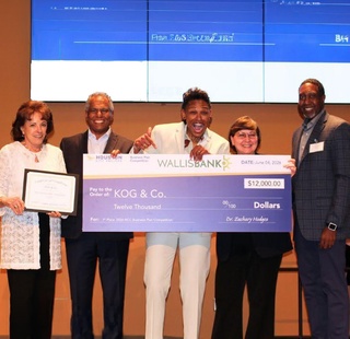 Business Plan Competition first prize winner Khaliah O. Guillory receiving his prize