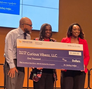 1 Minute Video Competition winner, Curious Vibezz, LLC – DeLisa Jones, receiving her award