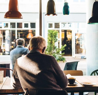 Person sat at table in a coffee shop