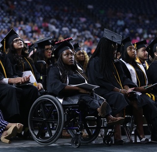 HCC graduates look up to the stage during Commencement.