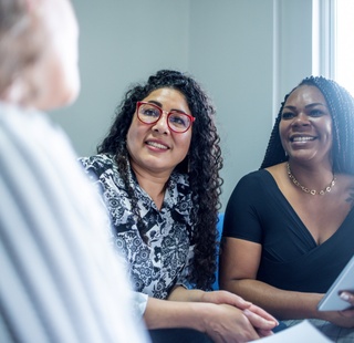 Female business professionals smiling and talking