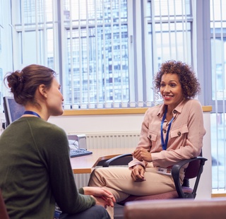 Advisor helping a student with their degree plan on a computer