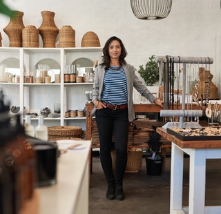 Small business owner in front of her boutique shop
