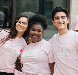 Three students pose for a photo while wearing HCC Student Life t-shirts.