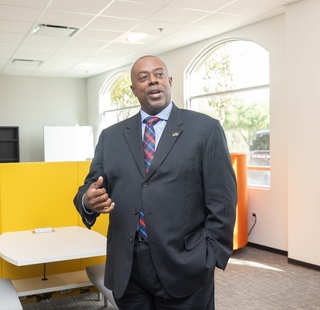 HCC Online College President Meet Dr. Jerome Drain speaks during an event.