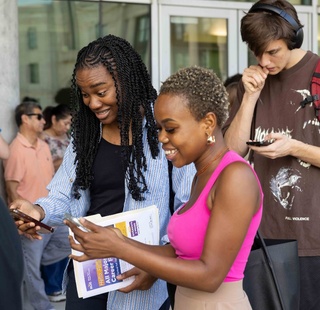 HCC students look at their phones during a Student Life event.