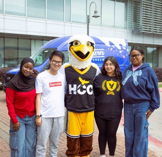 HCC Northeast College students pose for a photo with HCC mascot Swoop.