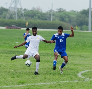 An HCC soccer player attempts to kick the ball during a game.