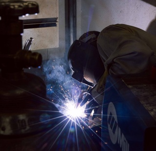 A student welds during a workforce training lab.