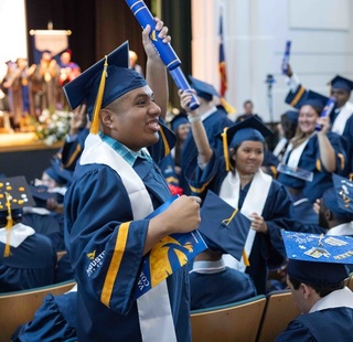 A VAST Academy graduate celebrates with his classmates during a Commencement Ceremony.