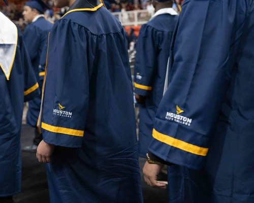 Houston City College graduates walking down the aisle in their regalia