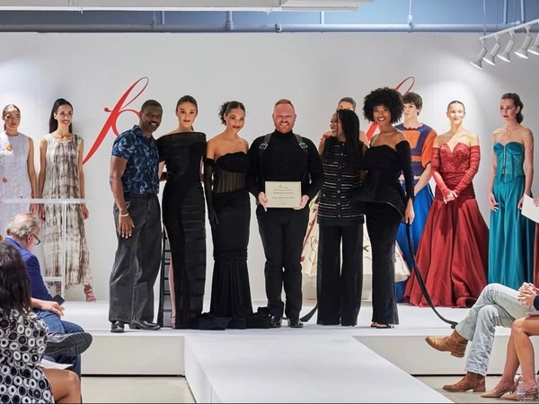 Eggleston Wooldridge (center) earned the Paris American Academy Couture Award during the FGI Dallas Scholarship Competition, which will afford him the opportunity to study abroad in Paris this summer.