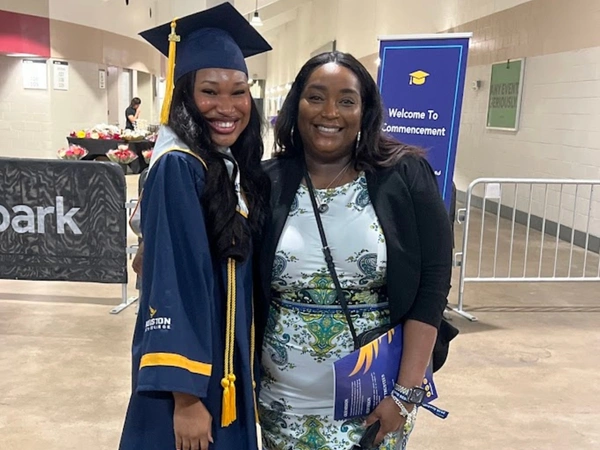 Isabelle Arusiuka and Iszella Flowers, supervisor, Student Accounts, pose for a photo at the HCC Spring 2026 Commencement Ceremony.
