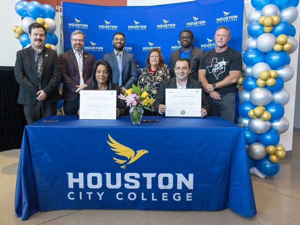 Seated front: Chancellor Margaret Ford Fisher, Ed.D.; Javier Corral Astorga, Tesla director of operations at Megafactory Texas  Standing (L-R): Ricky Baeza, Tesla; HCC Board of Trustees Vice Chair Sean Cheban; Atharva Amritkar, Senior Engineering Manager,  Tesla; HCC Board of Trustees Chair Eva Loredo; HCC Trustee Laolu Davies; Jeff Matheny, Senior Production Manager, Megafactory Texas, Tesla.