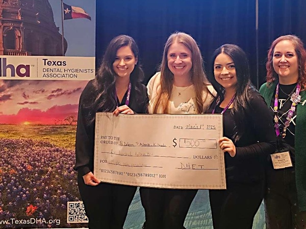 Pictured from left to right: Priscilla Alaniz, Kelsey Dumba, and Nohemi De Leon pose with a check.