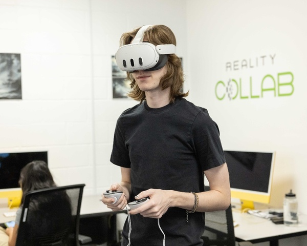 A student wears a VR headset in the Reality Collab space.