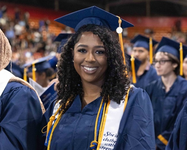 An HCC graduate smiles during the Commencement Ceremony.