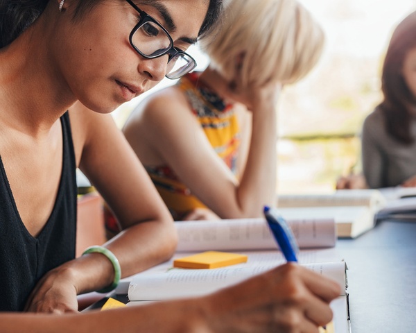 Student writing during class