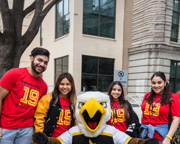 HCC students pose for a photo with HCC mascot Swoop.