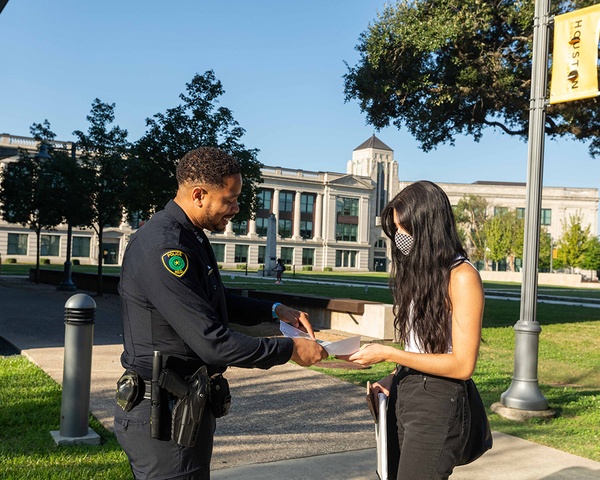 An HCC Police Officer helping a student on the Central Campus