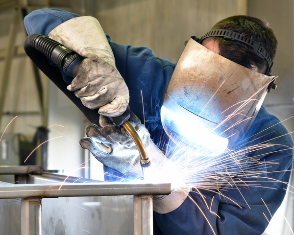A Welder using a welding machine