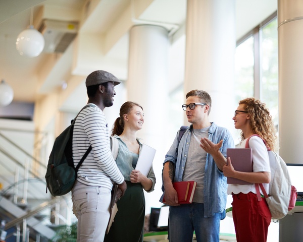 Students having a discussion in the hallway