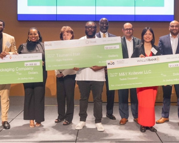 2025 HCC Business Plan Competition finalists hold up checks.