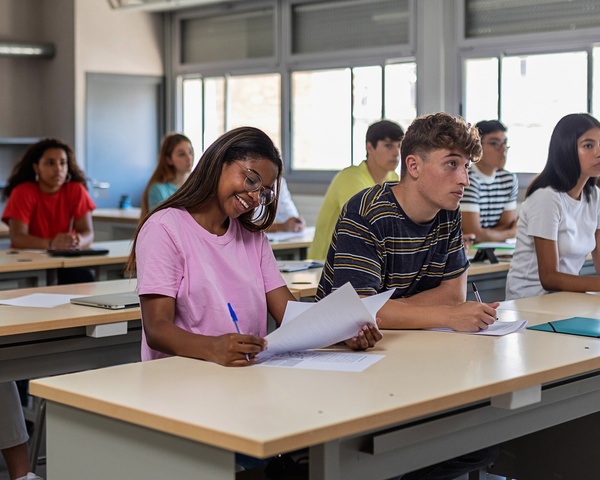 High school students working on schoolwork at a row of desks
