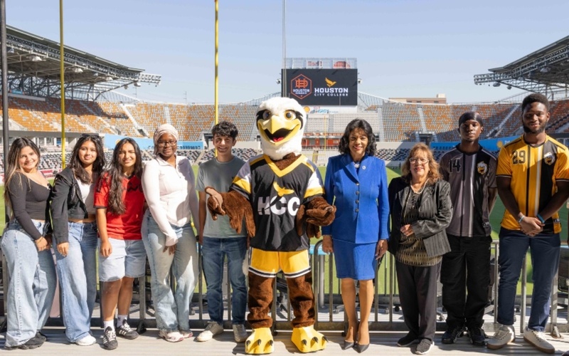 HCC students, the mascot Swoop and HCC officials pose for a photo Shell Energy Stadium.