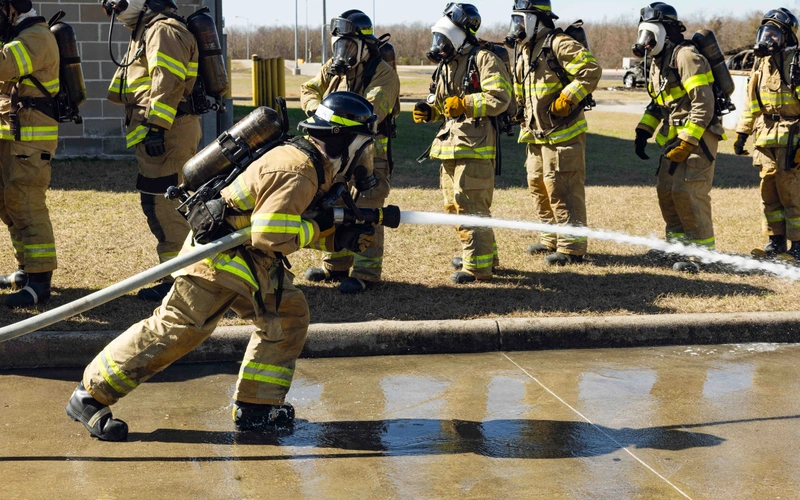 Fire academy students work on a drill using the fire hoses.