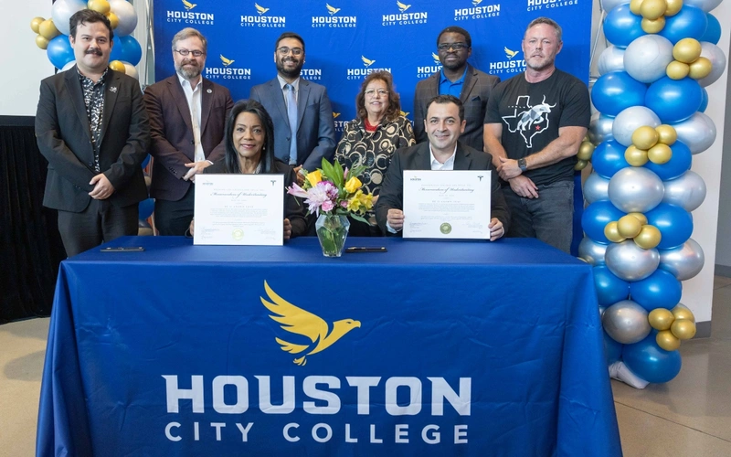 Seated front: Chancellor Margaret Ford Fisher, Ed.D.; Javier Corral Astorga, Tesla director of operations at Megafactory Texas  Standing (L-R): Ricky Baeza, Tesla; HCC Board of Trustees Vice Chair Sean Cheban; Atharva Amritkar, Senior Engineering Manager,  Tesla; HCC Board of Trustees Chair Eva Loredo; HCC Trustee Laolu Davies; Jeff Matheny, Senior Production Manager, Megafactory Texas, Tesla.
