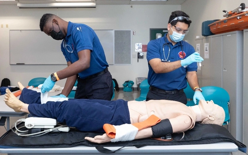 HCC Emergency Medical Services program students train with a mannequin.