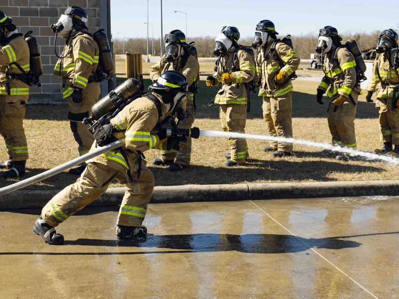Fire academy students work on a drill using the fire hoses.