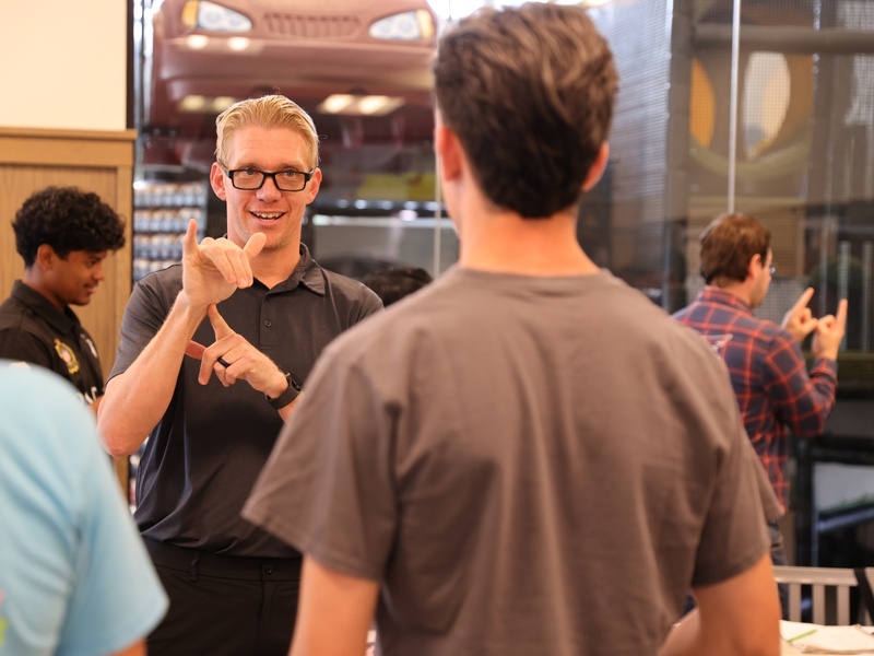 HCC American Sign Language student Jeremy Karnopp teaches sign language to Chick-fil-A employees.