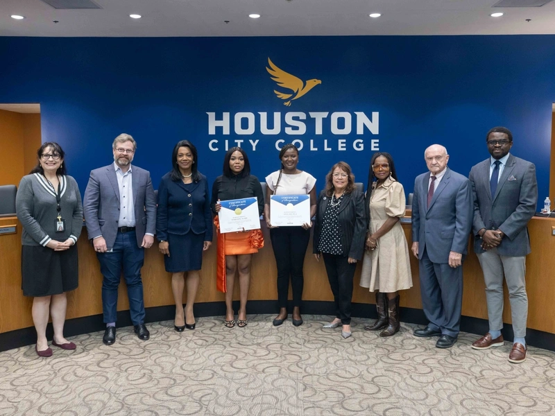 Students (L-R with certificates) Temitope Alabi and Afolake Ola pose with trustees and HCC Chancellor Margaret Ford Fisher. Ed.D.