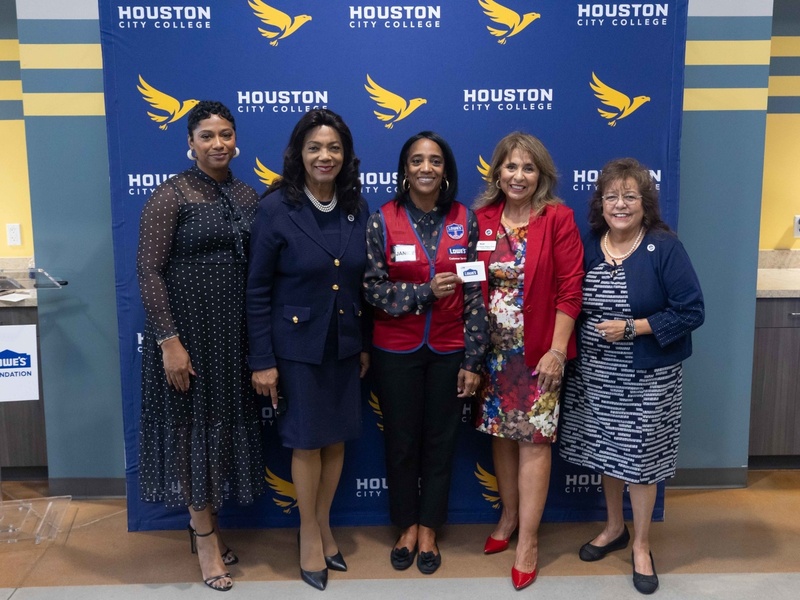 HCC officials pose for a photo with an official from Lowe's.