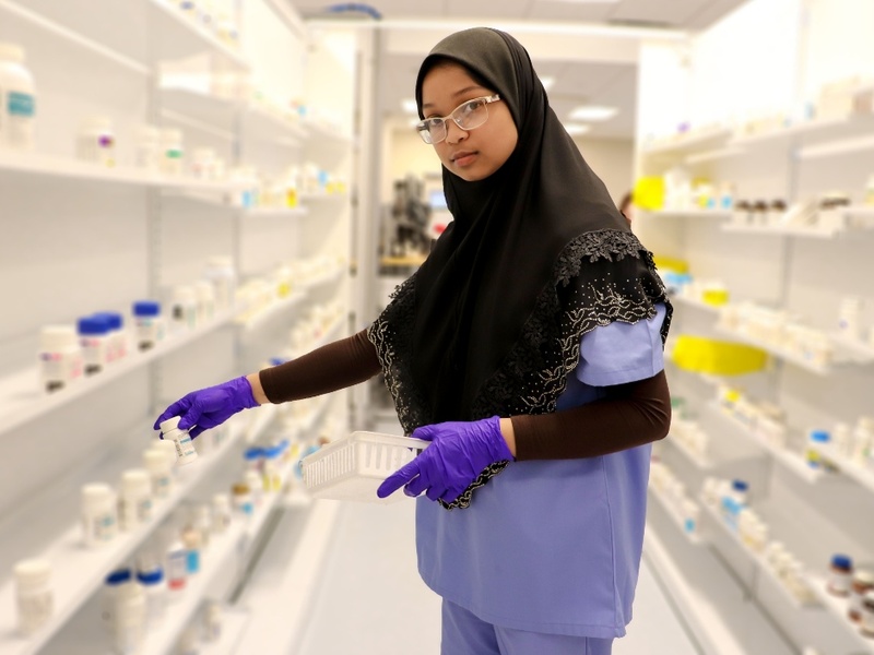 An HCC Pharmacy Tech Retail student poses for a photo.