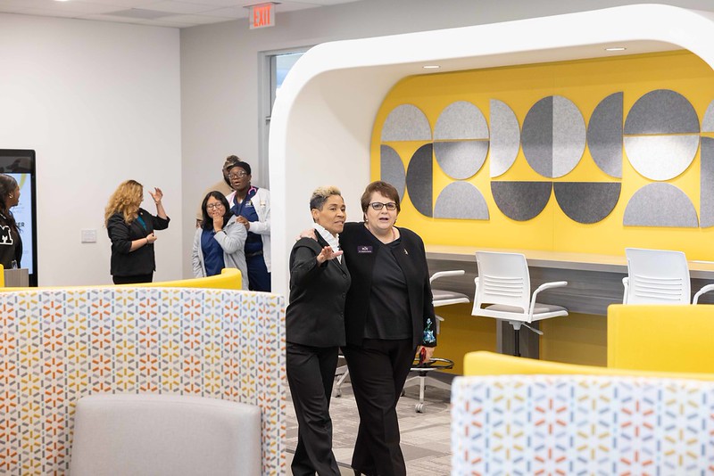 HCC staff members share a hug at the Digital Access Center.